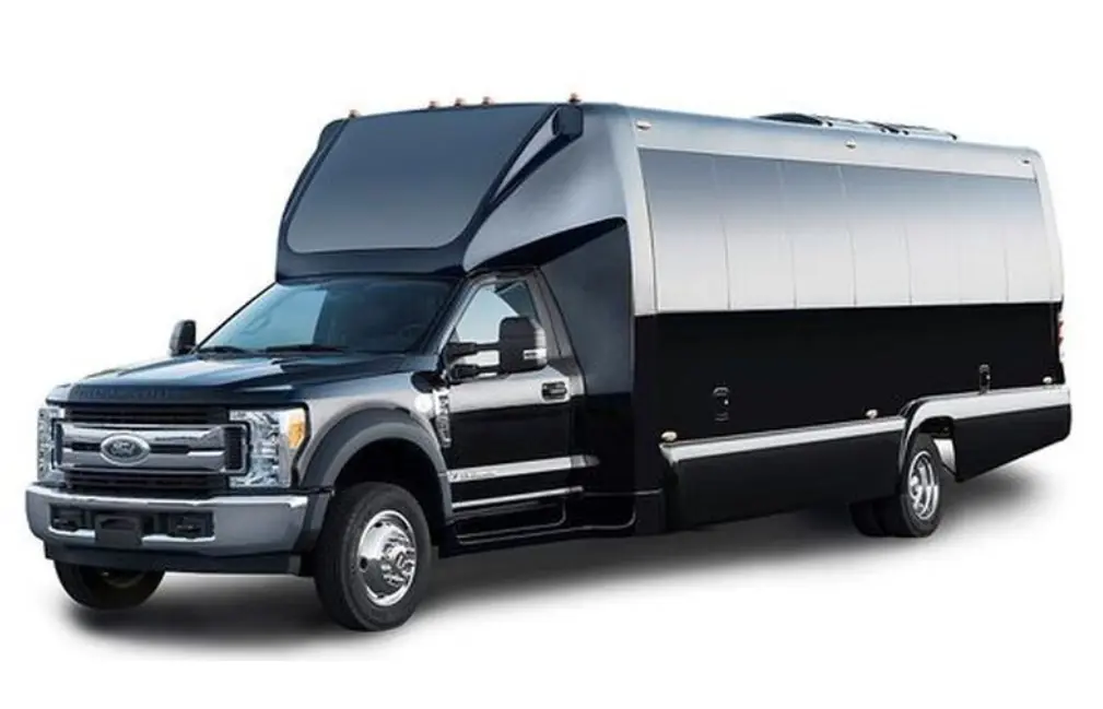 A black truck with a large black and silver trailer.